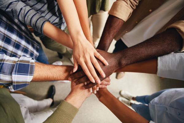 A group of stacked hands in a circle