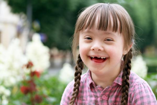 A smiling little girl with her hair in plaits